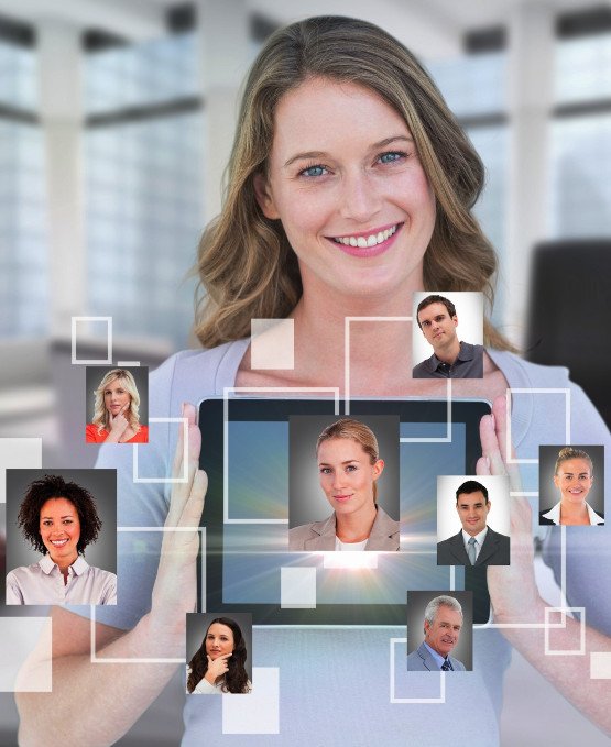 Smiling woman holding a tablet with headshots of various professionals connected in a virtual network around her. The image represents a digital or virtual team, online collaboration, or social networking, with a futuristic design of interconnected portraits.